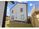 The backyard shows white siding, a walkout basement, new fence and an air conditioning unit at 35 N Keystone Ave, Indianapolis, IN 46201