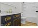 Bathroom featuring a modern navy vanity with marble countertop, gold hardware, and a white toilet at 35 N Keystone Ave, Indianapolis, IN 46201