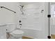 Bright bathroom featuring a white toilet and shower-tub with built-in shelving at 35 N Keystone Ave, Indianapolis, IN 46201