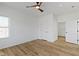 This bedroom has wood-look flooring and a modern ceiling fan with a light at 35 N Keystone Ave, Indianapolis, IN 46201