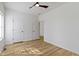 A bright bedroom with wood-look floors offers a ceiling fan and recessed lighting at 35 N Keystone Ave, Indianapolis, IN 46201