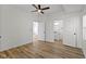 Spacious bedroom featuring a ceiling fan, wood flooring, and an ensuite bathroom at 35 N Keystone Ave, Indianapolis, IN 46201