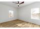 This bedroom has natural light, wood-look flooring and modern ceiling fan with light at 35 N Keystone Ave, Indianapolis, IN 46201