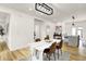 Elegant dining area with a modern table, hardwood floors, and an open view to the kitchen at 35 N Keystone Ave, Indianapolis, IN 46201