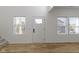 Bright entryway with a white door, hardwood floors, and natural light from two windows at 35 N Keystone Ave, Indianapolis, IN 46201