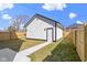 Detached garage with white siding, situated on a well-maintained lot with a pathway leading to the entrance at 35 N Keystone Ave, Indianapolis, IN 46201