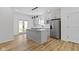 Stylish kitchen featuring gray cabinets, stainless steel appliances, and a center island at 35 N Keystone Ave, Indianapolis, IN 46201