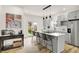 Stylish kitchen featuring gray cabinets, stainless steel appliances, and a large island with seating at 35 N Keystone Ave, Indianapolis, IN 46201
