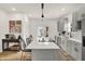 Well-lit kitchen boasting gray cabinets, a central island with seating, and modern appliances at 35 N Keystone Ave, Indianapolis, IN 46201