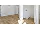 Bright laundry room featuring sleek hardwood floors and white walls at 35 N Keystone Ave, Indianapolis, IN 46201