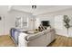 Comfortable living area with a plush sofa, hardwood floors, and ample natural light at 35 N Keystone Ave, Indianapolis, IN 46201