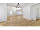Spacious living room with hardwood floors, high ceilings, and natural light leading to the bathroom at 35 N Keystone Ave, Indianapolis, IN 46201