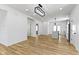 Open-concept living space with modern lighting, stainless appliances, and beautiful wood flooring at 35 N Keystone Ave, Indianapolis, IN 46201