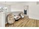Modern loft featuring bright wood-look flooring, papasan chairs, and a unique, modern light fixture at 35 N Keystone Ave, Indianapolis, IN 46201