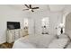 Light-filled bedroom with television, ensuite bathroom and dining area access at 35 N Keystone Ave, Indianapolis, IN 46201