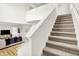 Well-lit staircase with plush carpeting leading to an upper level overlooking the open living space at 35 N Keystone Ave, Indianapolis, IN 46201