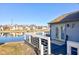 Back of house featuring a deck with white railings overlooking a pond and other houses at 4042 Eagle Cove East Dr, Indianapolis, IN 46254