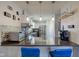 Kitchen featuring breakfast bar with seating, white cabinets, and modern appliances at 4042 Eagle Cove East Dr, Indianapolis, IN 46254