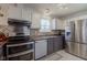 Kitchen featuring stainless steel appliances, tiled backsplash, and lots of storage at 4042 Eagle Cove East Dr, Indianapolis, IN 46254