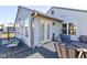 View of the sunroom with many windows and access to the black wooden deck with outdoor furniture at 4042 Eagle Cove East Dr, Indianapolis, IN 46254