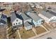 Bright aerial view of charming blue and gray homes featuring neat landscaping and inviting front porches at 418 Sanders St, Indianapolis, IN 46225