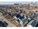 An aerial view of a residential neighborhood, featuring modern homes and a city skyline in the background at 418 Sanders St, Indianapolis, IN 46225