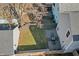 An aerial view of a backyard with a patio, lush lawn, and a privacy fence at 418 Sanders St, Indianapolis, IN 46225