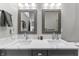 Elegant bathroom featuring a double vanity, framed mirrors, and modern fixtures at 418 Sanders St, Indianapolis, IN 46225