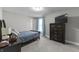 Cozy bedroom showcasing a bed, dresser with television, and soft blue accents at 418 Sanders St, Indianapolis, IN 46225
