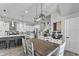 Modern dining room with a long wood table, white chairs, and statement lighting above the table at 418 Sanders St, Indianapolis, IN 46225