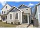 Charming gray two-story home featuring blue trim, landscaped yard, and inviting front porch at 418 Sanders St, Indianapolis, IN 46225
