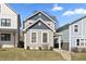 Inviting two-story home with gray siding, blue accents, and well-maintained front yard at 418 Sanders St, Indianapolis, IN 46225