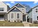 Charming two-story home featuring gray siding, blue accents, and well-maintained front yard at 418 Sanders St, Indianapolis, IN 46225