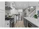 Stylish kitchen with stainless steel appliances, an island with barstool seating, and modern cabinetry at 418 Sanders St, Indianapolis, IN 46225