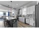 Open-concept kitchen with a large island, stainless appliances, sleek cabinetry, and hardwood flooring at 418 Sanders St, Indianapolis, IN 46225