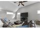 Relaxing living room with leather sectional sofa, plush ottoman, and ceiling fan at 418 Sanders St, Indianapolis, IN 46225