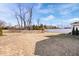 Large backyard provides ample space for recreation, complemented by mature trees and play structure at 4544 W Rising Sun Dr, New Palestine, IN 46163