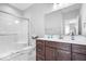 This bathroom includes a walk-in shower with glass doors and dark wood cabinets at 4544 W Rising Sun Dr, New Palestine, IN 46163