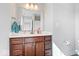 Bathroom boasts dark wood vanity, a large mirror, and elegant fixtures, complemented by neutral tones at 4544 W Rising Sun Dr, New Palestine, IN 46163