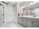Bright bathroom features double sinks, gray cabinets, and a wide vanity mirror at 4544 W Rising Sun Dr, New Palestine, IN 46163