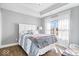 This bedroom features a tray ceiling, bright window, and hardwood flooring at 4544 W Rising Sun Dr, New Palestine, IN 46163