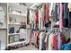 Walk-in closet with custom shelving and clothing racks for optimal organization at 4544 W Rising Sun Dr, New Palestine, IN 46163