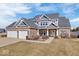 A brick home with a three-car garage and a well-manicured lawn at 4544 W Rising Sun Dr, New Palestine, IN 46163