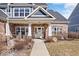 Charming brick home featuring a covered front porch and landscaped yard at 4544 W Rising Sun Dr, New Palestine, IN 46163