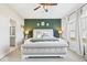 This main bedroom includes an upholstered headboard, bench, and a feature wall at 4544 W Rising Sun Dr, New Palestine, IN 46163