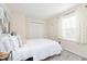 Cozy bedroom with a comfortable bed and light-filtering curtains over the window at 4629 Indianola Ave, Indianapolis, IN 46205