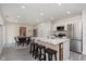 Bright and modern kitchen boasting a large island with seating, stainless steel appliances, and an adjacent dining area at 4629 Indianola Ave, Indianapolis, IN 46205