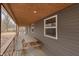 Covered porch features a picnic table, wood ceilings and ample space for entertaining at 4629 Indianola Ave, Indianapolis, IN 46205