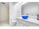 Modern bathroom featuring white subway tile, a blue glass bowl sink, and a skylight for natural light at 504 Bent Tree Ln, Indianapolis, IN 46260