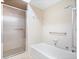 Well-maintained bathroom with shower-tub combination featuring glass sliding door and bright neutral colors at 504 Bent Tree Ln, Indianapolis, IN 46260